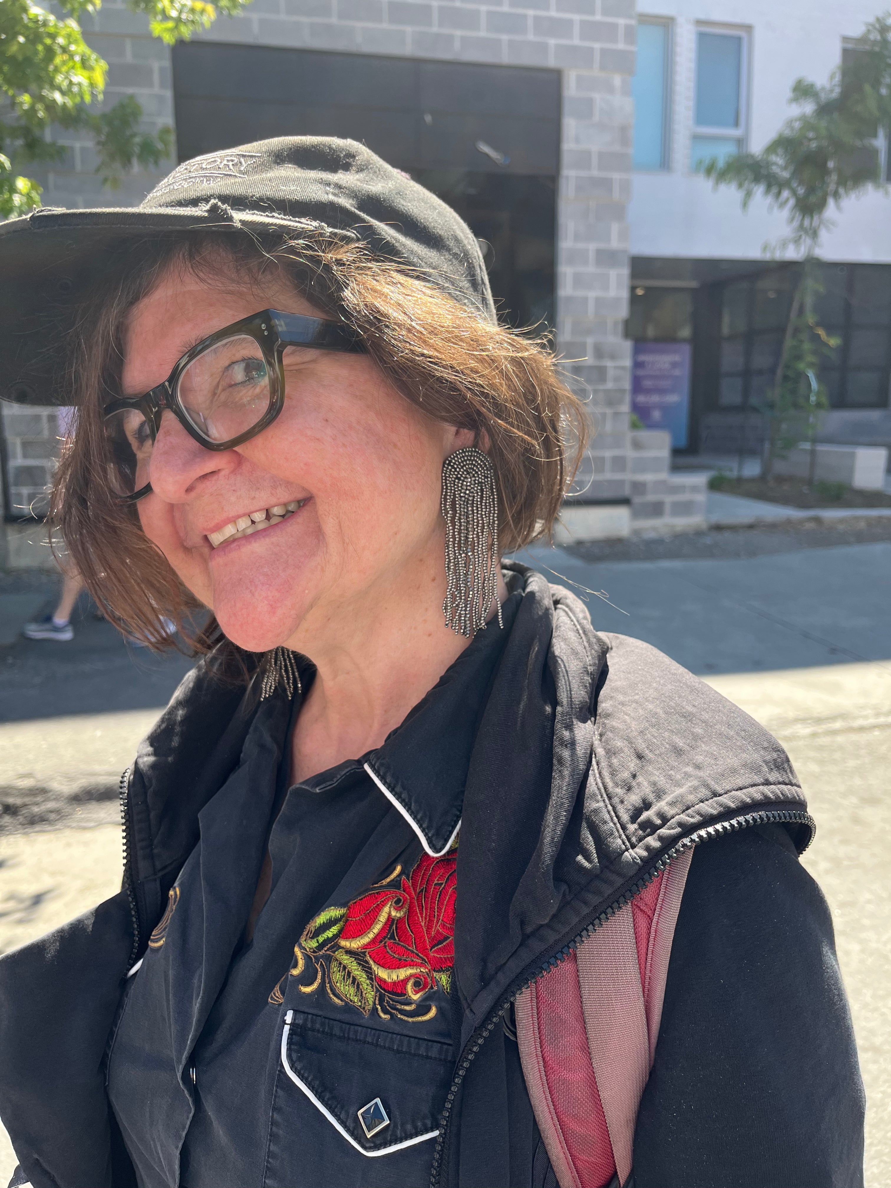Customer wearing handmade beaded accessories at an outdoor market | Zohricanada