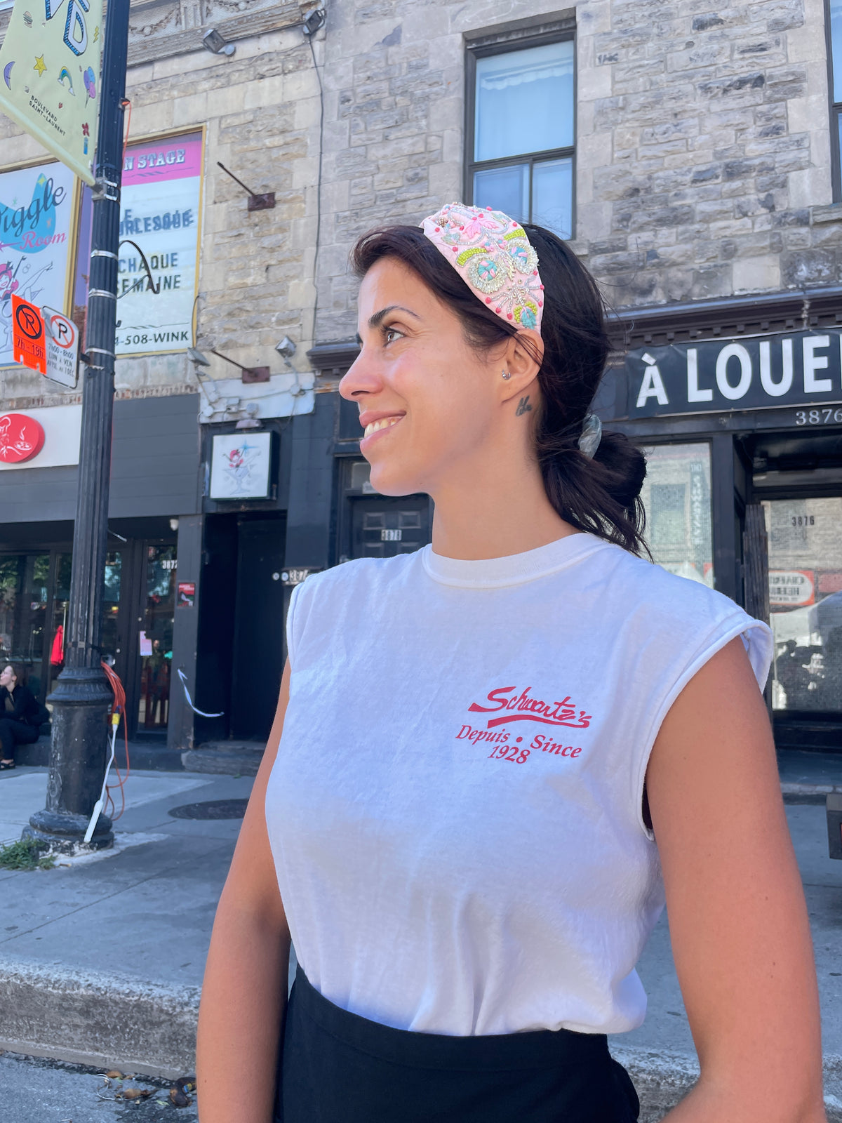 Customer wearing a handmade pastel beaded knotted headband on a city street | Zohricanada