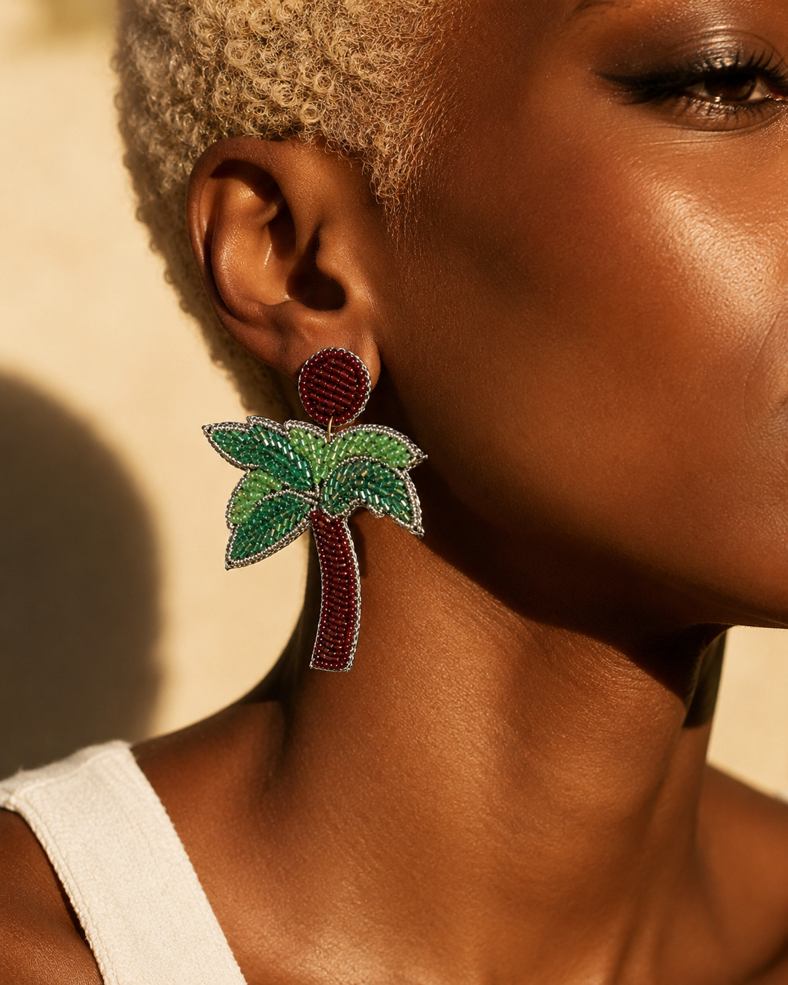 Model wearing handmade red and green beaded palm tree earrings | Zohricanada