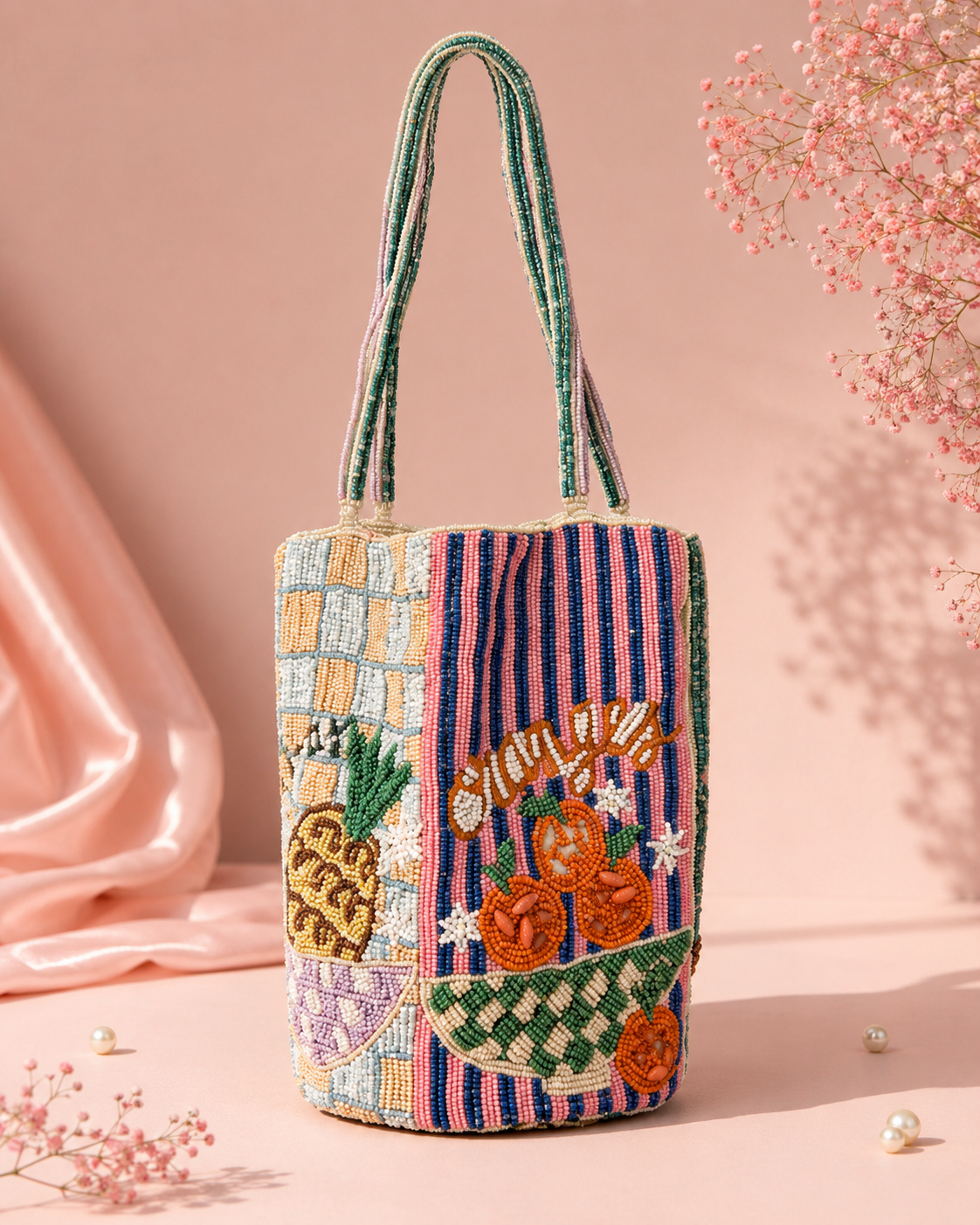 Handmade Fruit Market Beaded Tote Bag for Women | Luxury Vacation & Gift Handbag — Handmade beaded fruit market tote bag with pineapple and orange embroidery by ZOHRICANADA on a pink background with flowers — Zohricanada