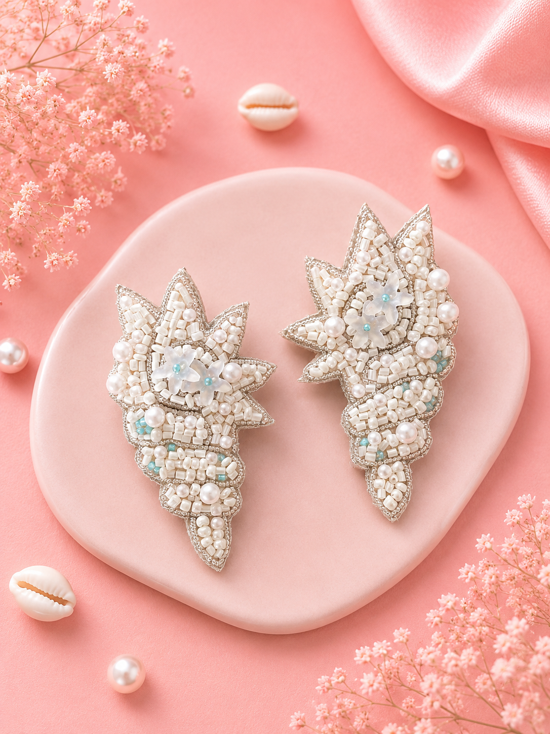Ocean Shell Earrings — Handmade white and silver beaded star shell earrings by ZOHRICANADA, displayed on a pink surface with pearls and dried flowers — Zohricanada